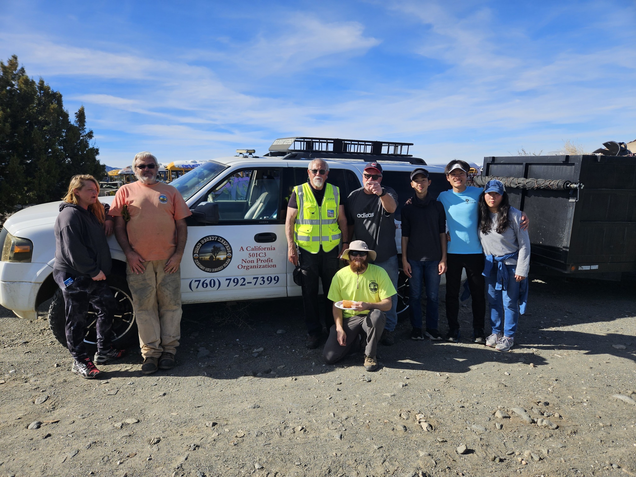 High Desert Keepers volunteers gathered beside an organization vehicle and cleanup trailer